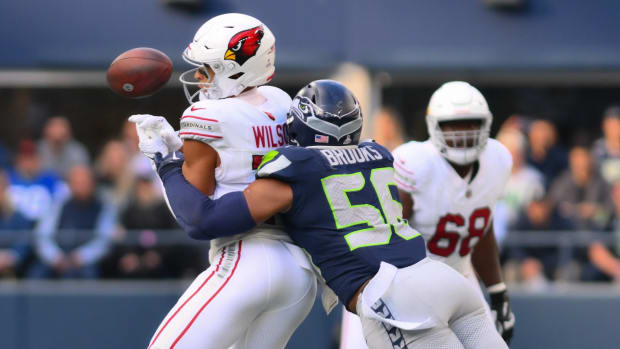 Seattle Seahawks linebacker Jordyn Brooks (56) breaks up a pass to Arizona Cardinals wide receiver Michael Wilson (14) during the second half at Lumen Field.